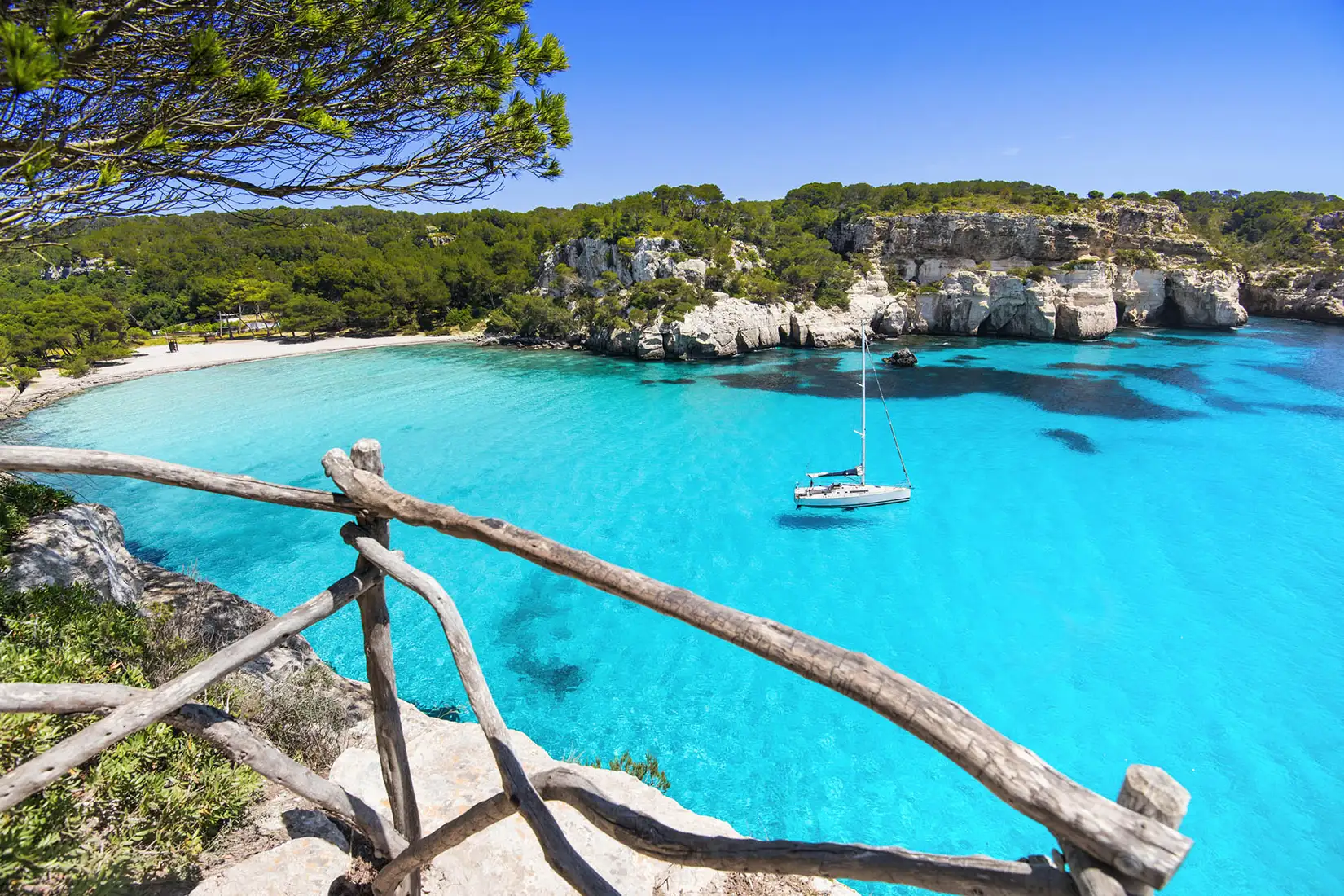 Blick auf Cala en Brut, einen Strand auf Menorca, mit türkisfarbenden Wasser
